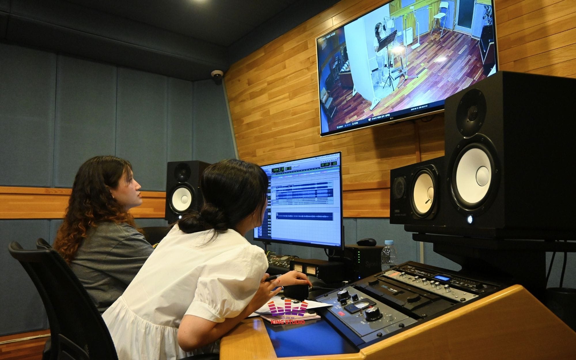 Vocal director providing recording guidance during K-Pop experience Seoul trip