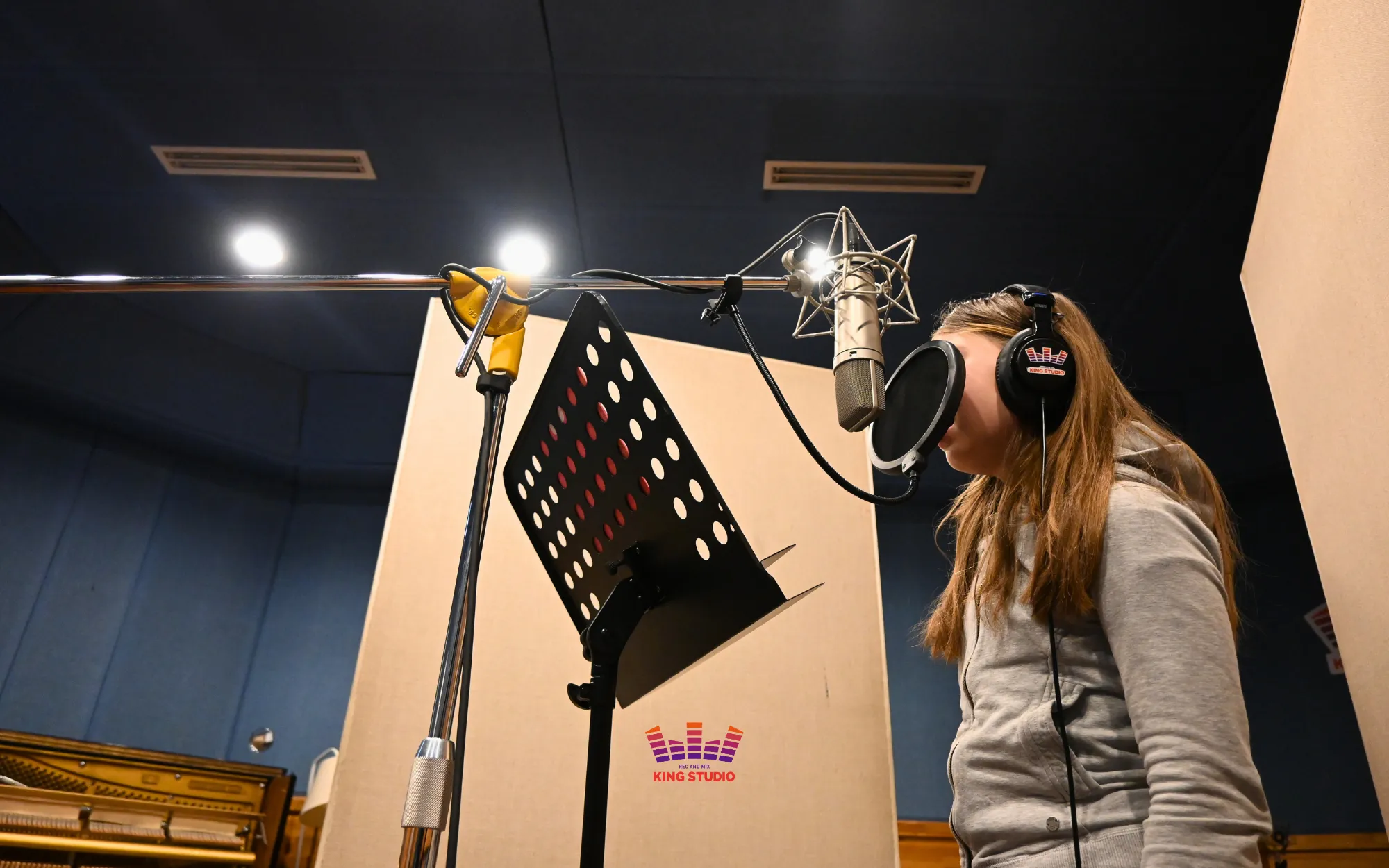Alina running the full song in the booth, headphones on, during rehearsal