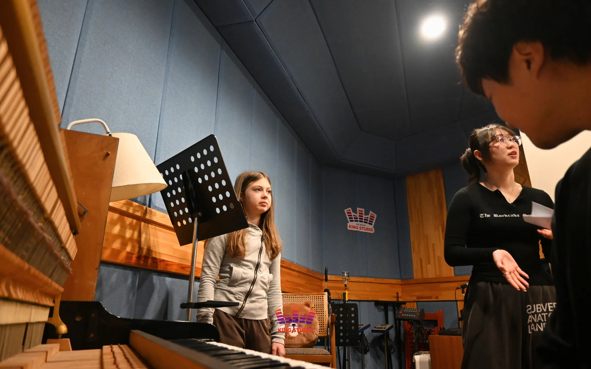 Alina warming up her voice with vocal director Seung Won ahead of recording