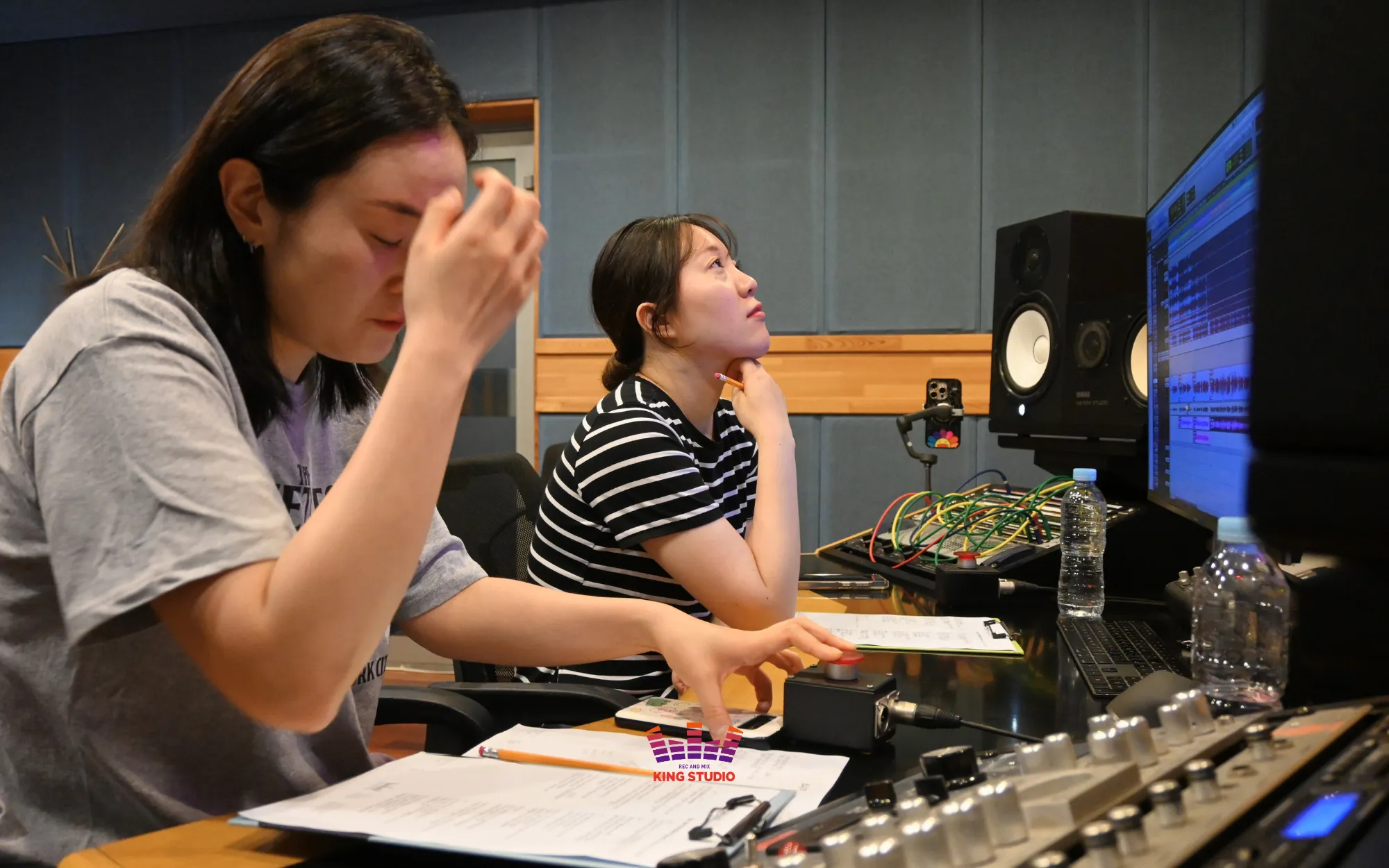 Vocal director giving real-time pronunciation and timing directions during recording