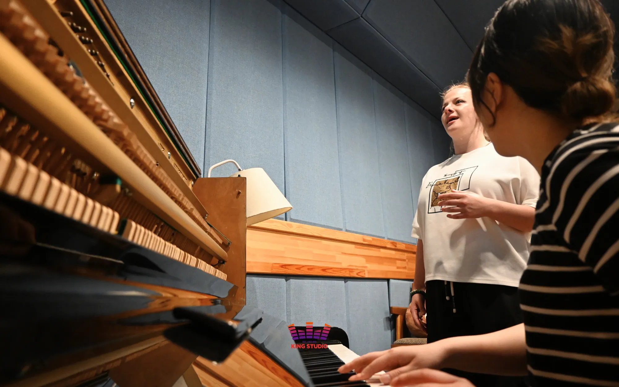 Vocal director Lucia leading a vocal training warm-up with Kaoru before recording