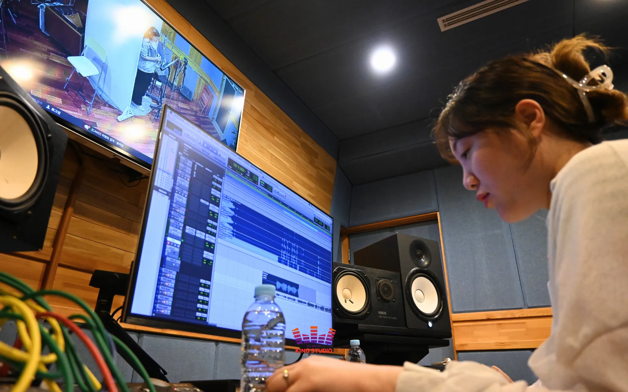 Vocal Director Lucia directing from the control room during Wu Yuan's session