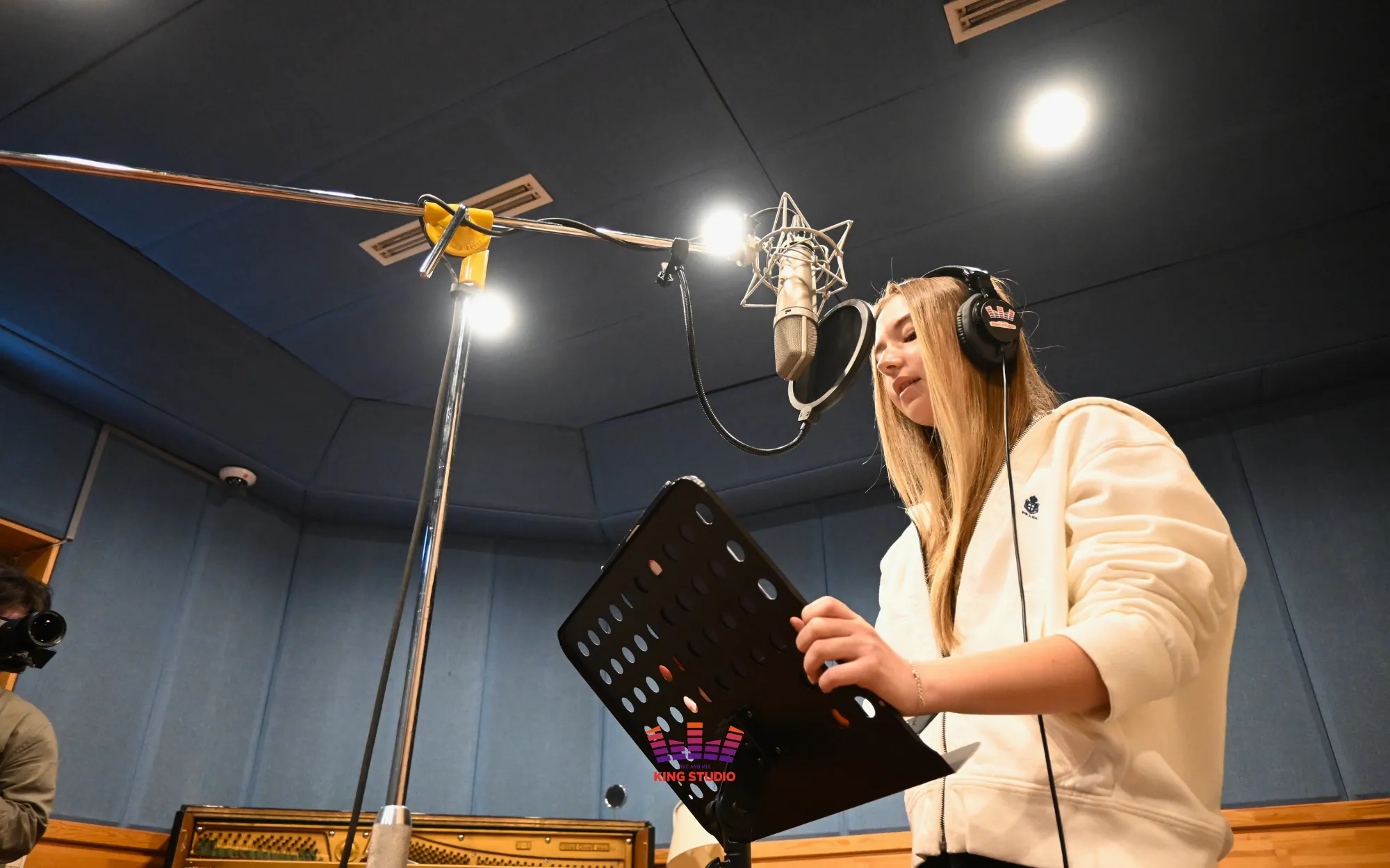 Kira and her grandfather recording their duet idol-style in the booth