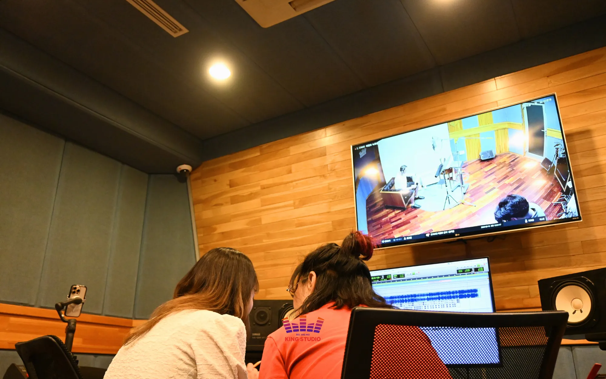 Lusia directing Kira toward a brighter tone for the duet harmony