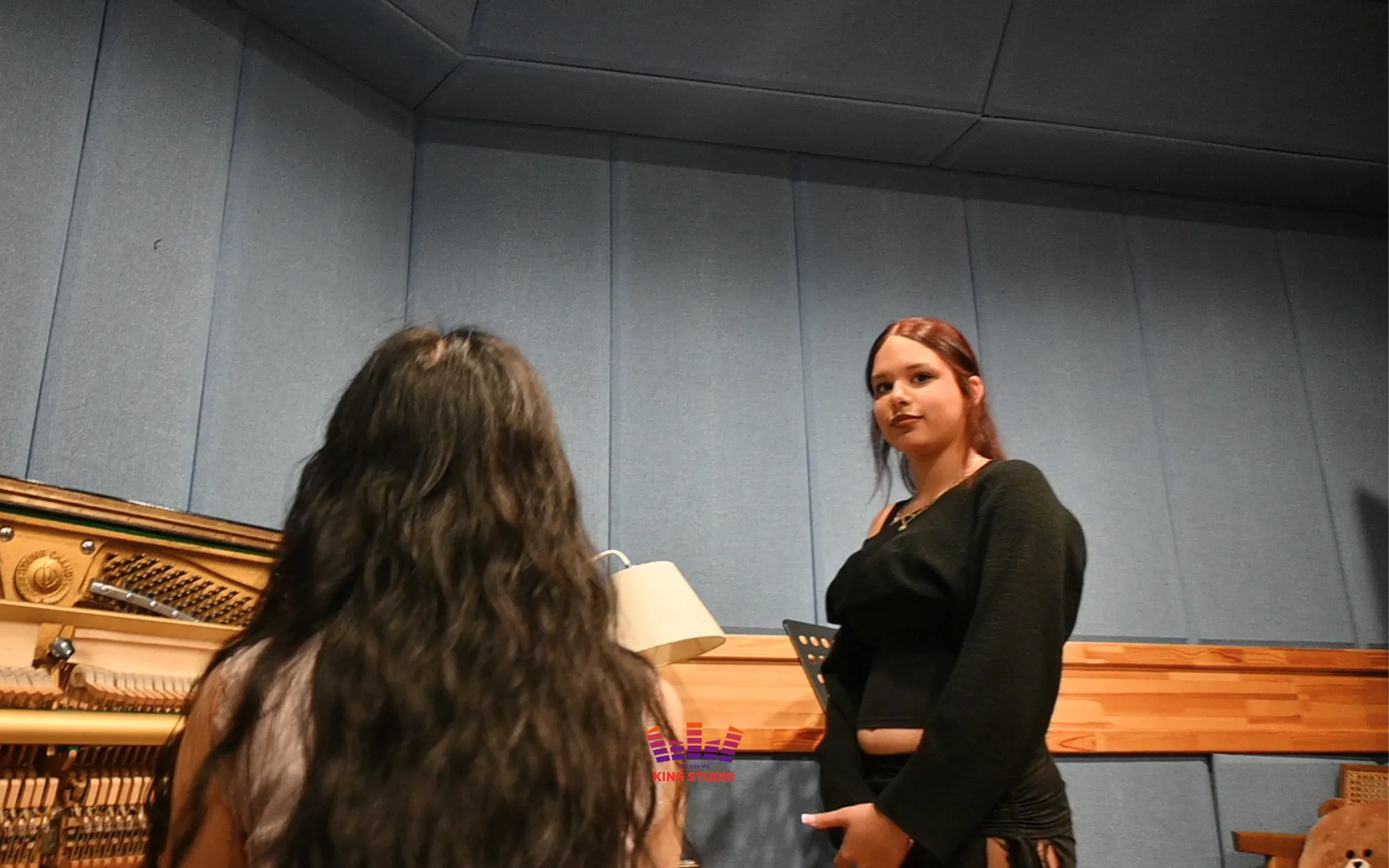 Vocal director checking mic distance in the KING STUDIO recording booth